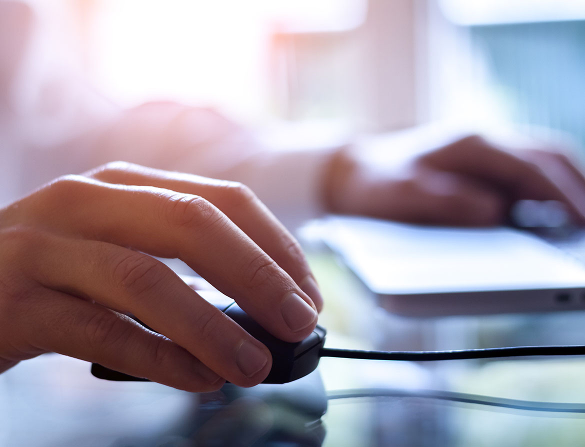 Photo of a person's hands using a computer