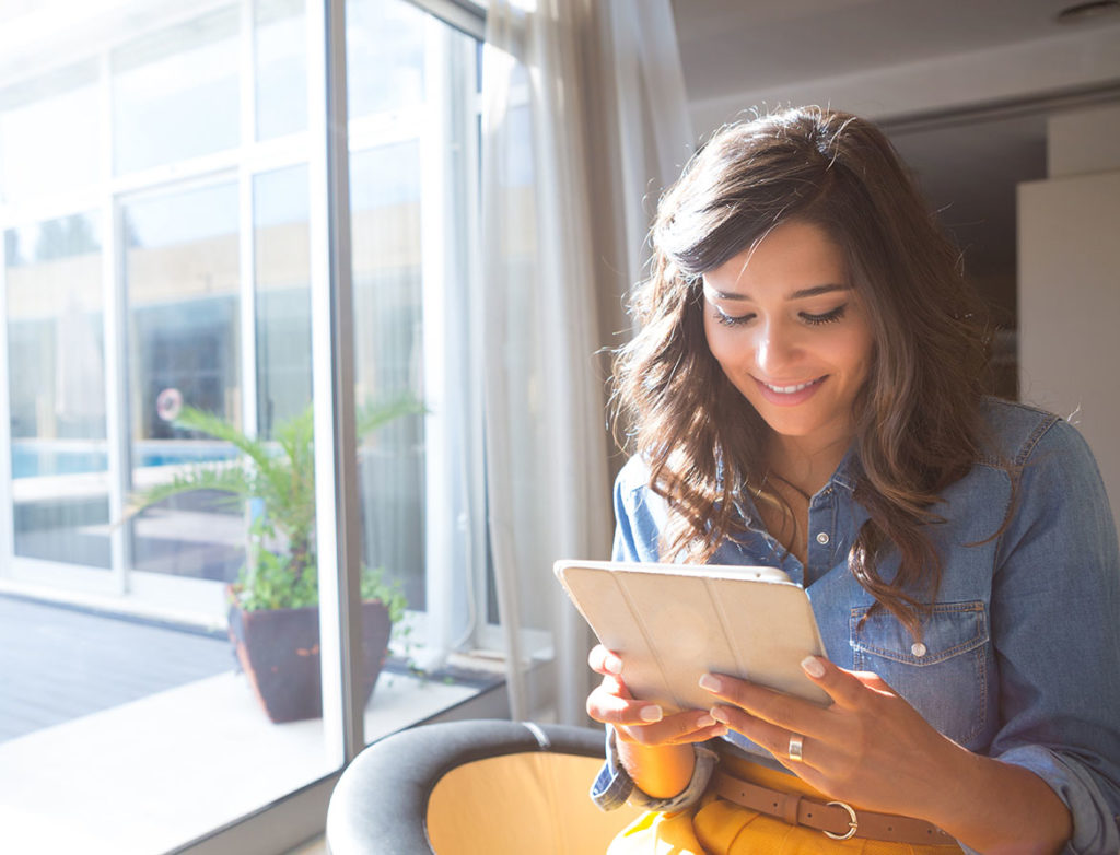 Photo of a young woman using a tablet